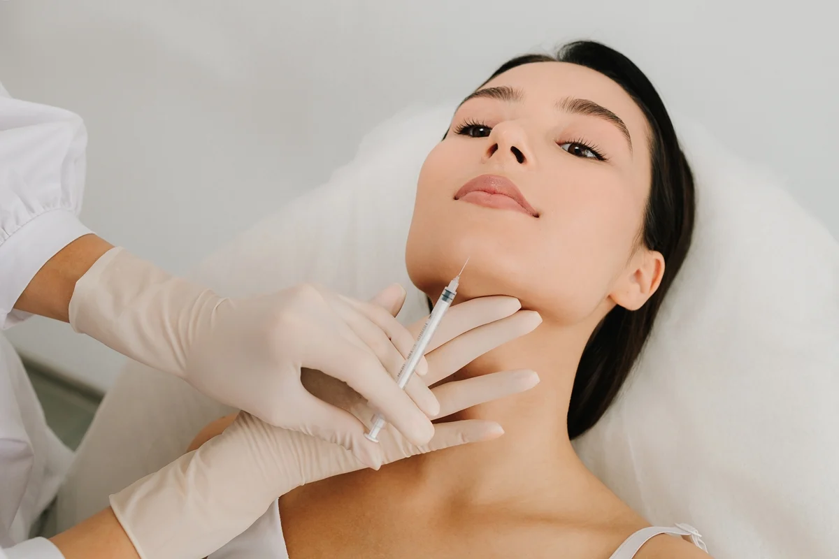 Woman receiving Sculptra injection for facial aging